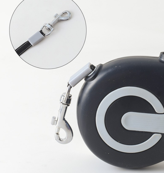 Close up of the black retractable lead showing the metal clip and nylon rope