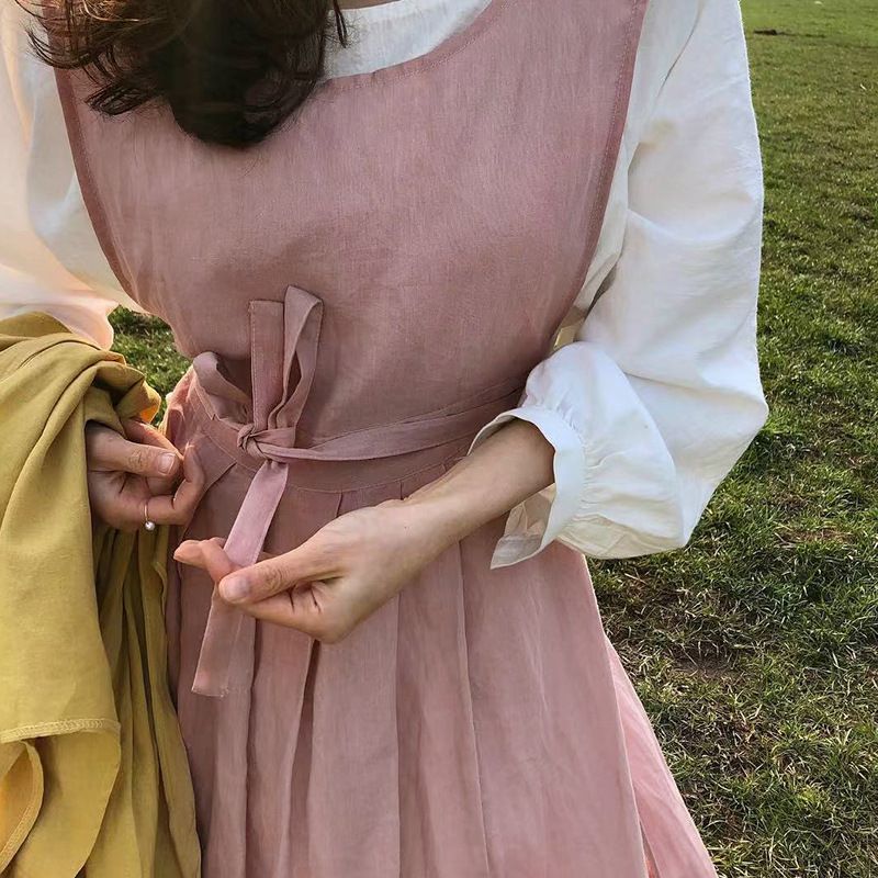 Close up of the garden apron waist ties being fastened at the back