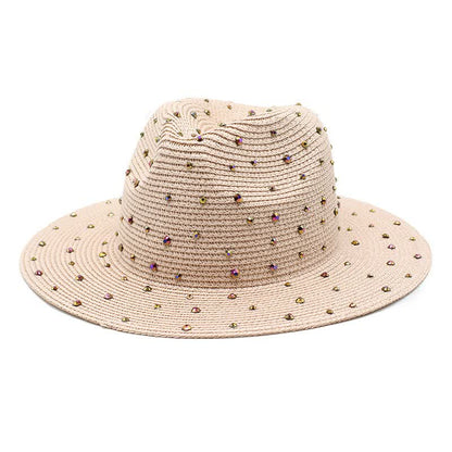 Pink wide brim straw hat with rhinestones on a white background