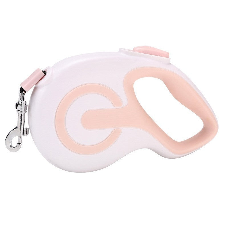 Pink retractable dog lead with anti slip grip on a white background